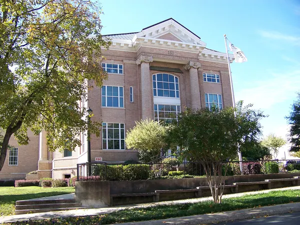 The historic Gaston County Courthouse, a tan brick building with columns