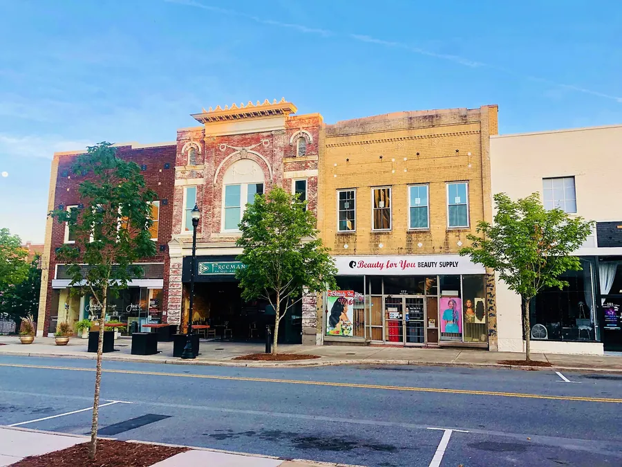 Brick and tan storefronts on a sunny morning in downtown Gastonia